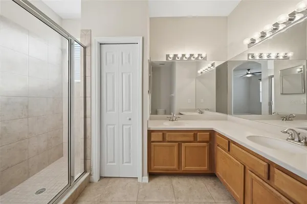 a spacious bathroom with a double vanity sink mirror and double