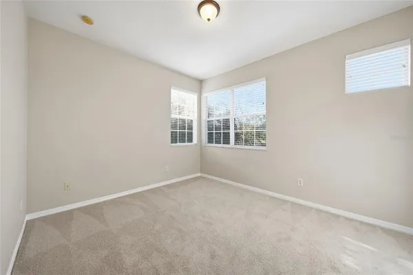 an empty room with windows and closet