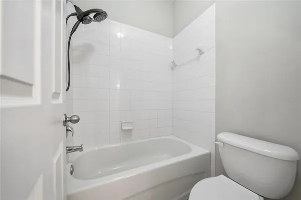 a bathroom with a toilet and a bath tub