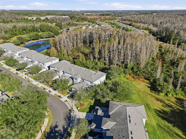 an aerial view of residential houses with outdoor space
