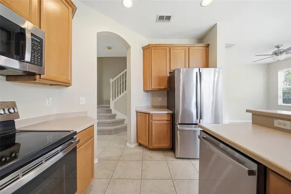 a kitchen with a refrigerator stove and microwave