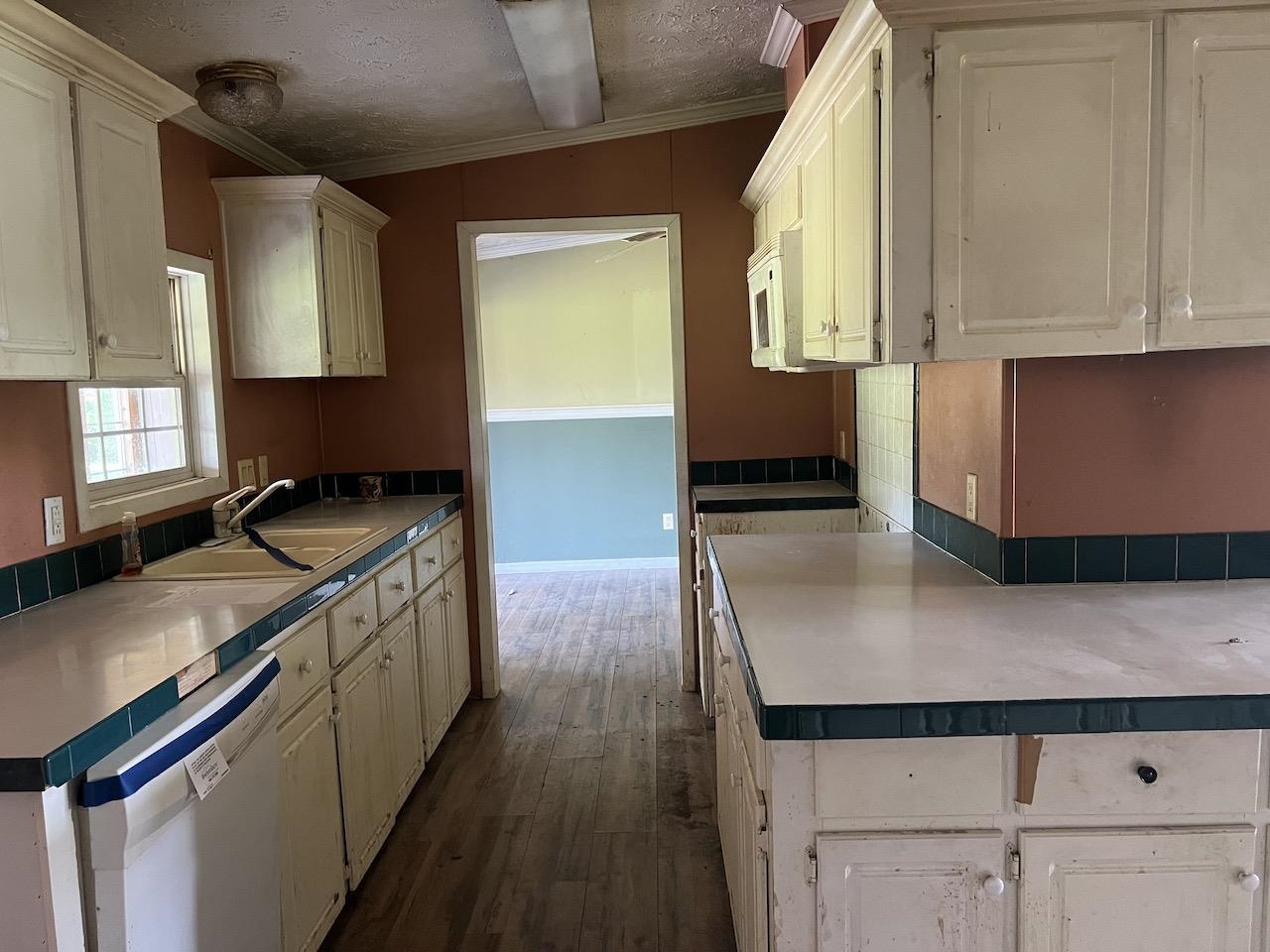 760 Wadsworth Road Henning, TN 38041 - Photo 6 of 15 a kitchen with stainless steel appliances granite countertop a stove a sink and a microwave