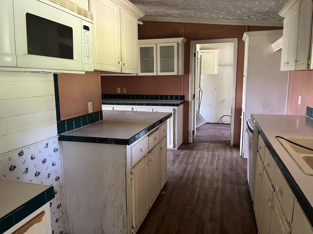 760 Wadsworth Road Henning, TN 38041 - Photo 7 of 15 a kitchen with stainless steel appliances granite countertop a stove and a microwave