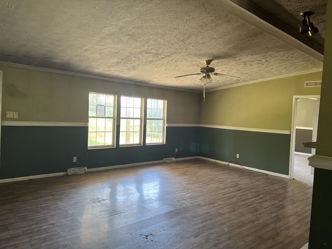 760 Wadsworth Road Henning, TN 38041 - Photo 8 of 15 an empty room with wooden floor and windows