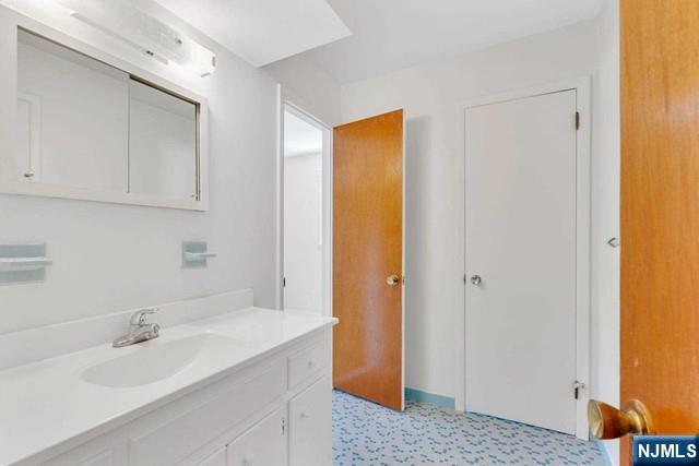 516 Knickerbocker Road Cresskill, NJ 07626 - Photo 25 of 31 a bathroom with a sink and a mirror