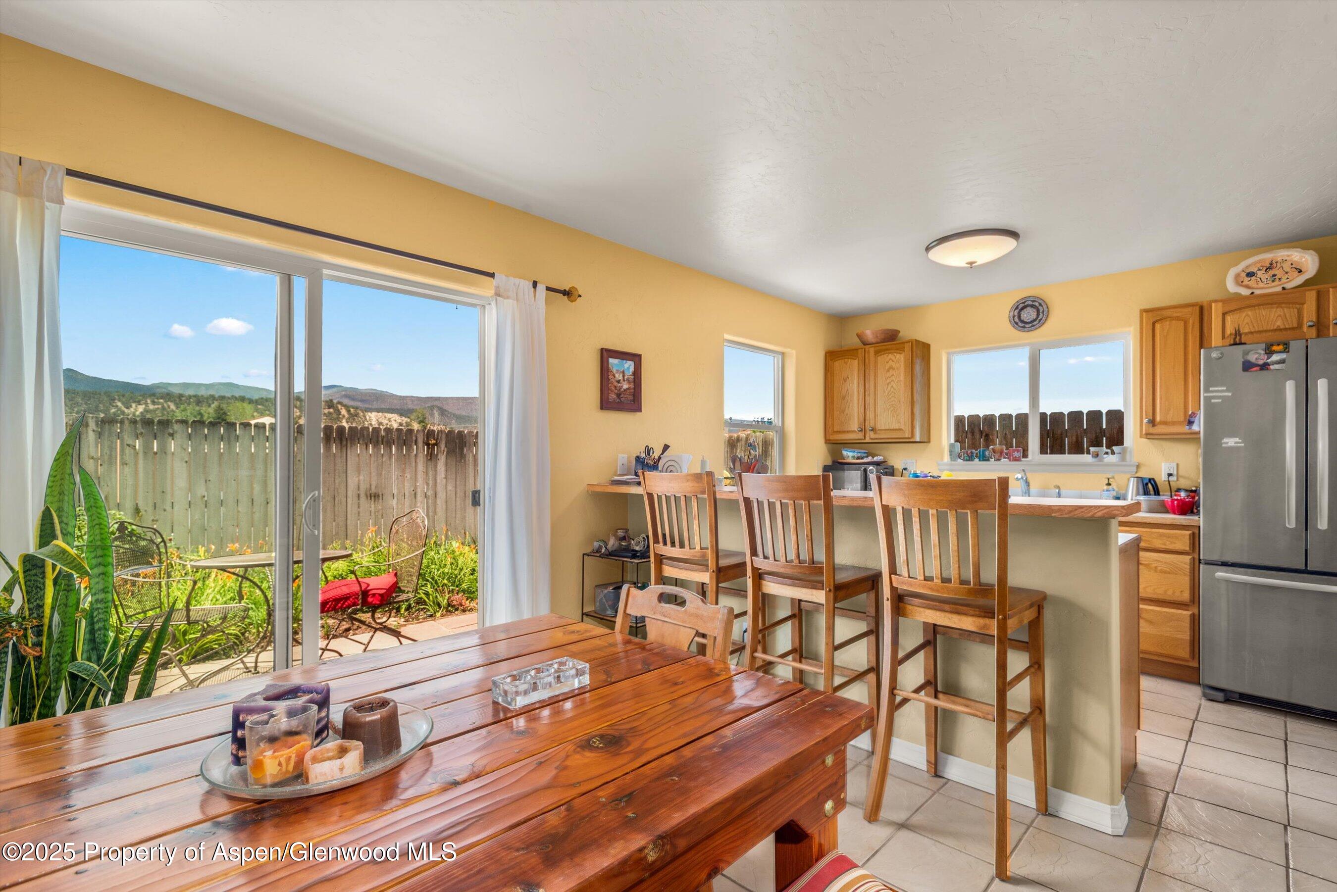 1070 Village Road Carbondale, CO 81623 - Photo 11 of 30 a dining room with furniture water view and a floor to ceiling window