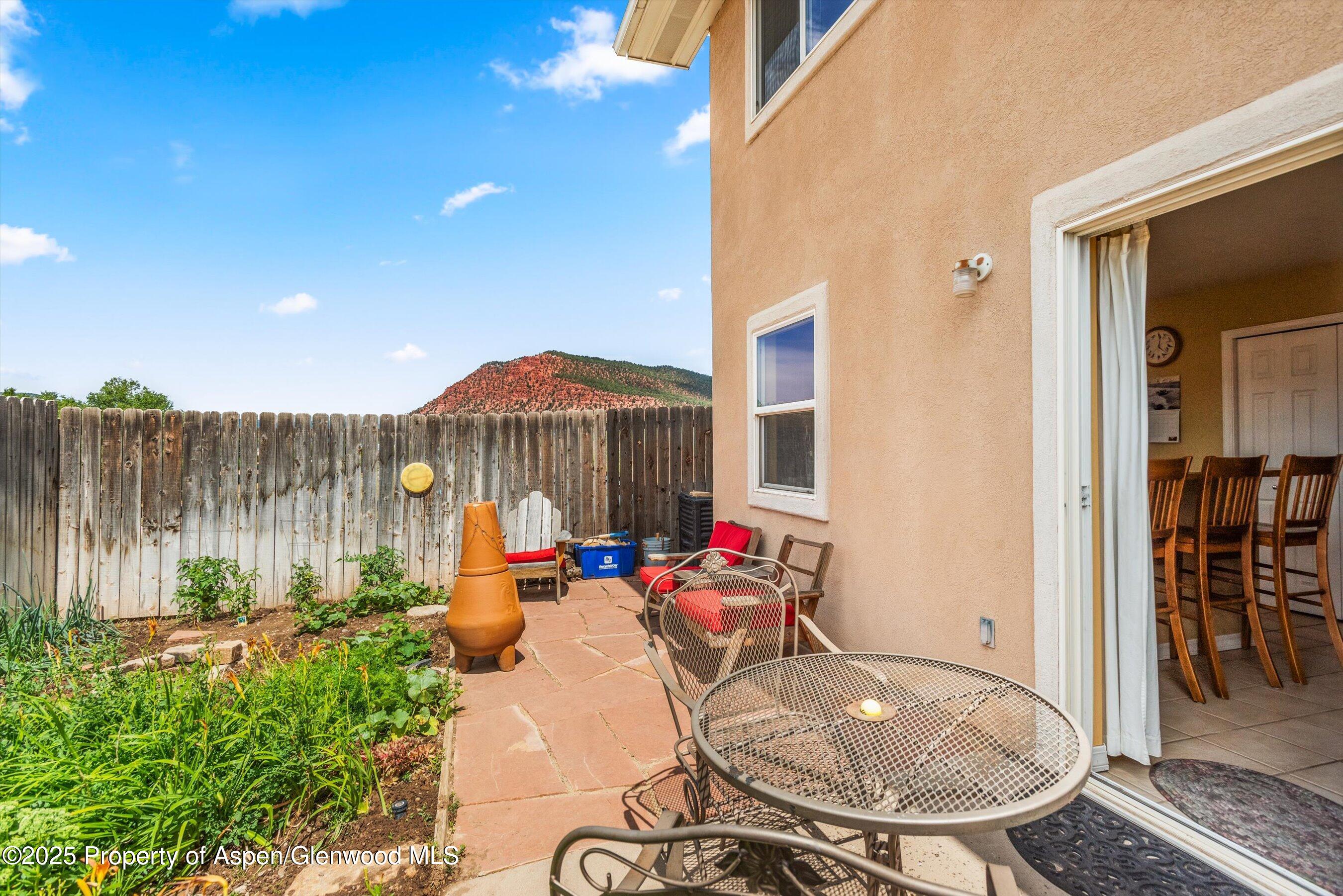 1070 Village Road Carbondale, CO 81623 - Photo 18 of 30 a backyard of a house with yard table and chairs