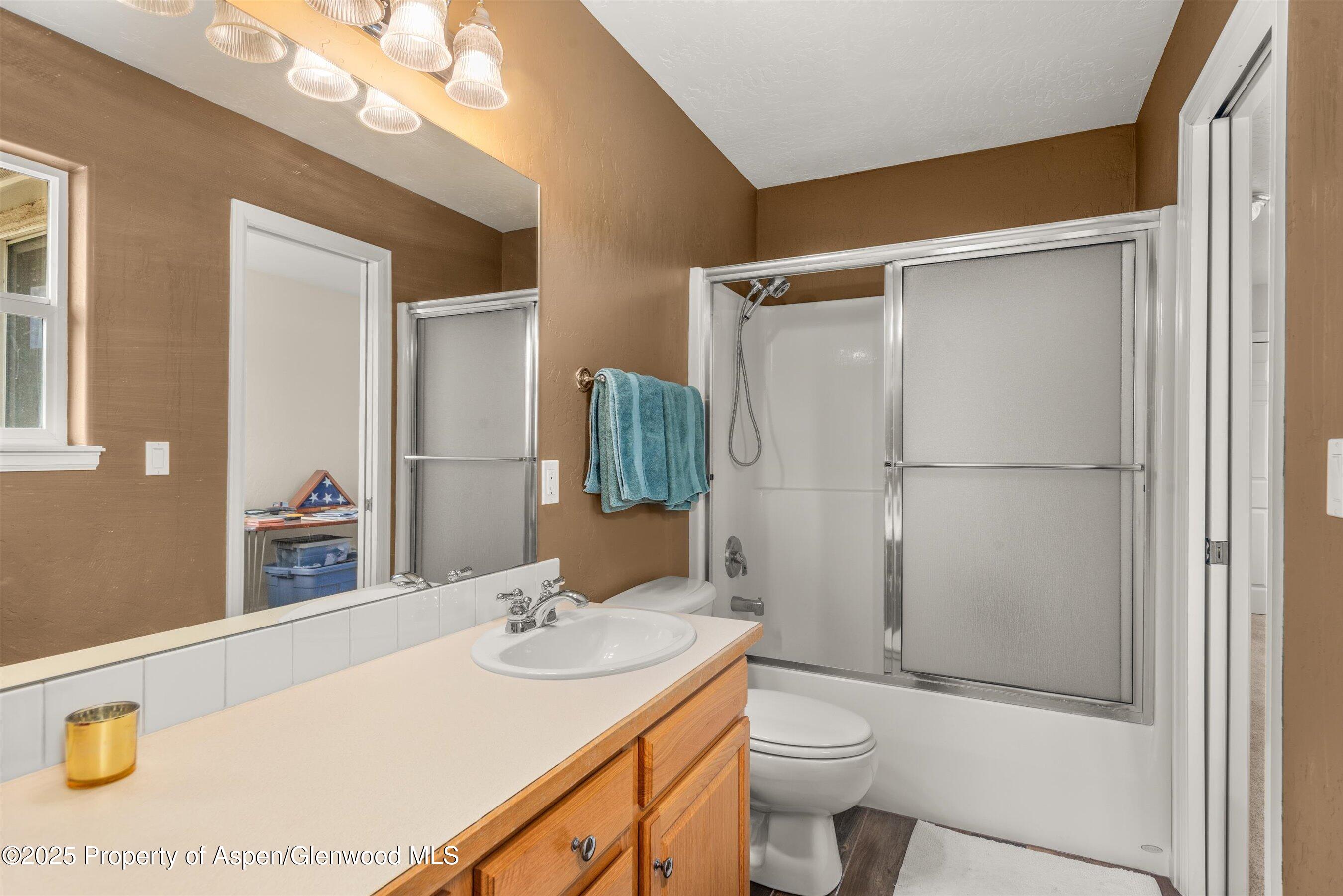 1070 Village Road Carbondale, CO 81623 - Photo 27 of 30 a bathroom with a sink a toilet and shower