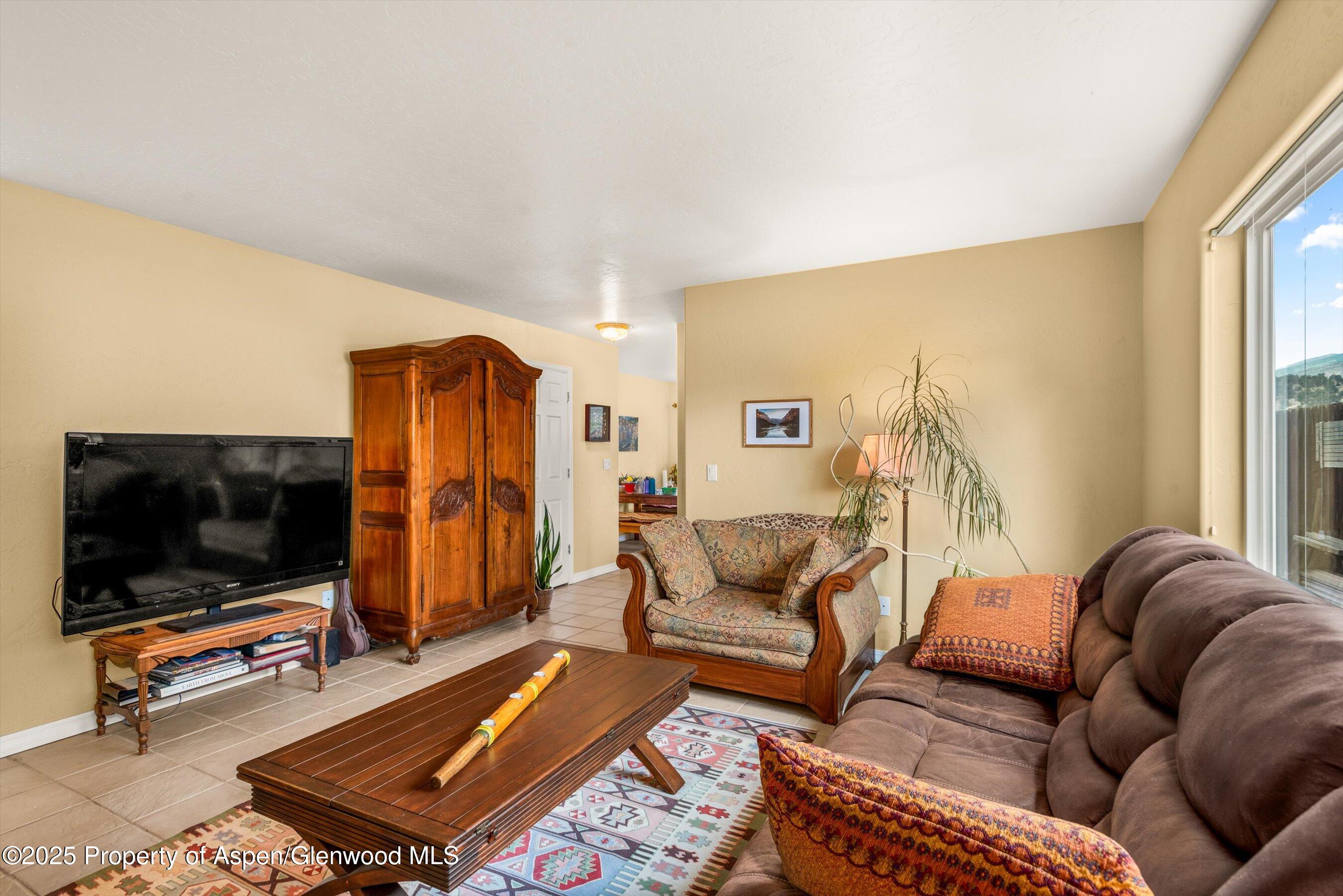 1070 Village Road Carbondale, CO 81623 - Photo 6 of 30 a living room with furniture and a flat screen tv