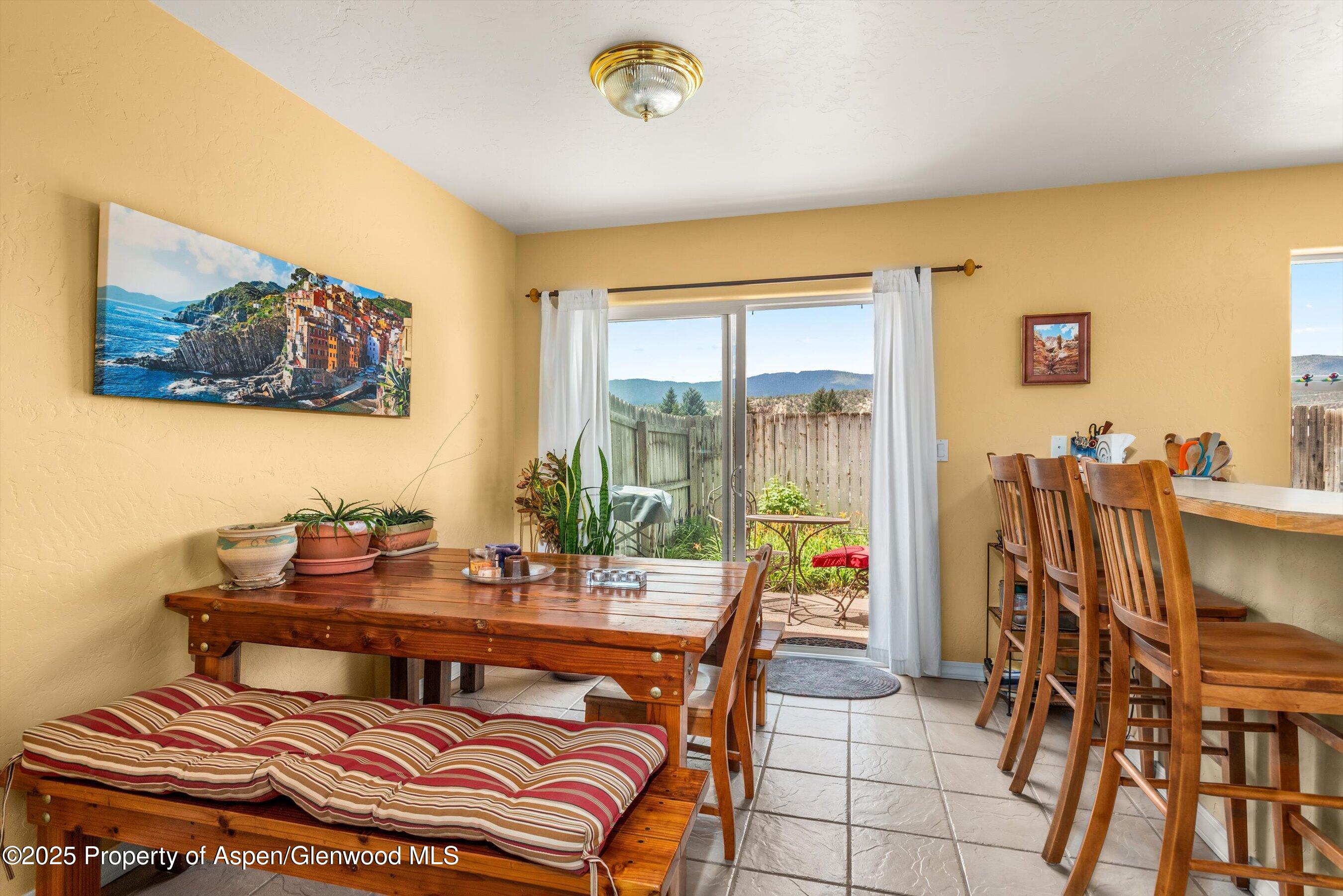1070 Village Road Carbondale, CO 81623 - Photo 10 of 30 a dining room with furniture and a floor to ceiling window