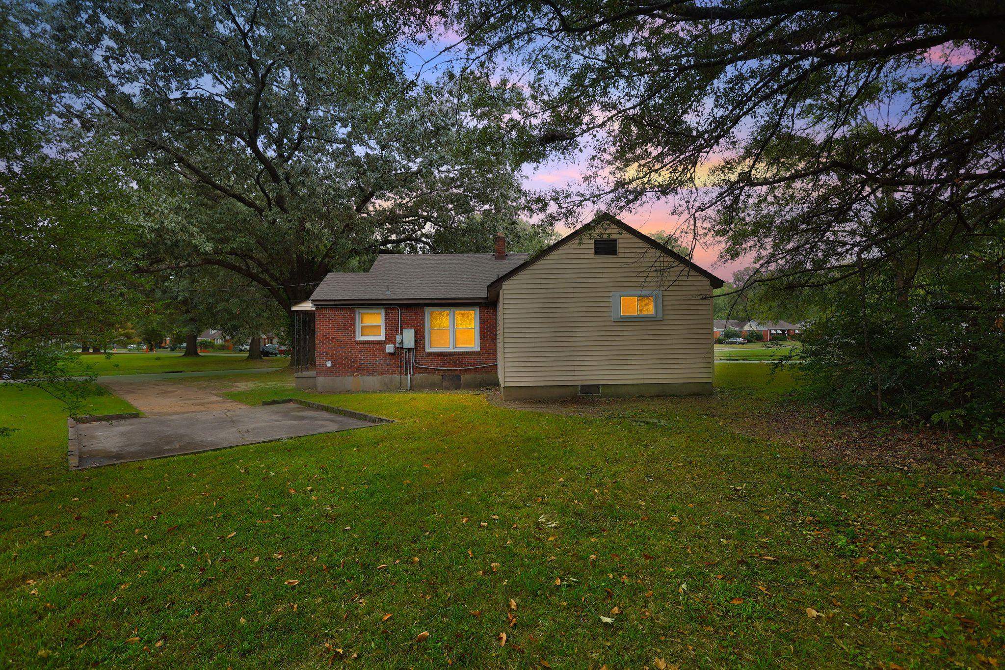 1563 Flamingo Road Memphis, TN 38117 - Photo 31 of 38 Rear view of house with a yard, brick siding, and crawl space