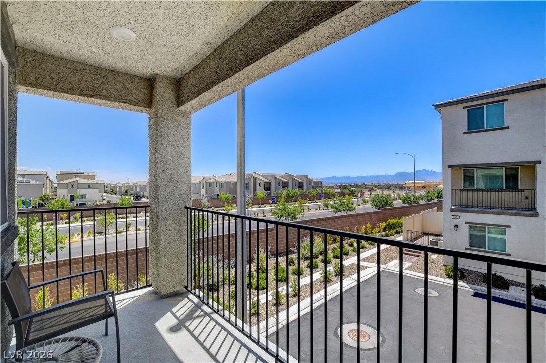 6924 Spicy Merlot Street North Las Vegas, NV 89086 - Photo 40 of 83 An inviting balcony overlooks a landscaped common area and neighborhood with distant mountain vistas.