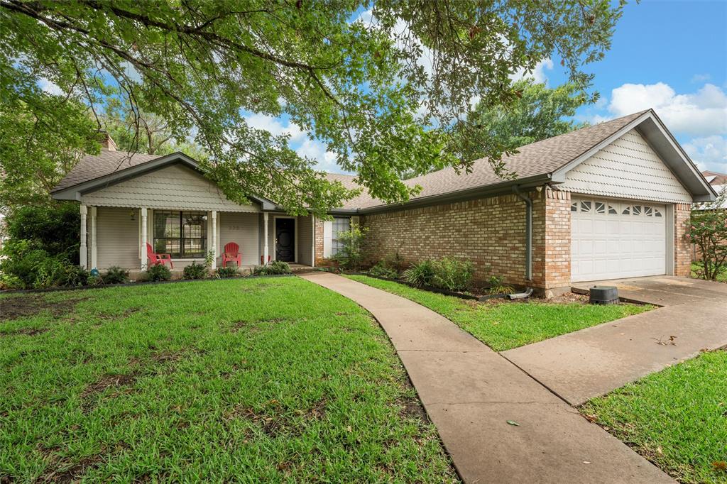 335 East Chapman Road Hewitt, TX 76643 - Photo 1 of 1 Ranch-style home featuring a front yard, an attached garage, brick siding, driveway, and roof with shingles