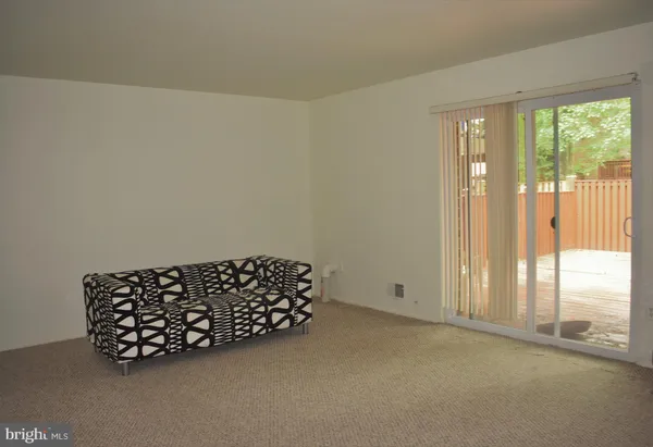 a wooden bench sitting in a room next to a window