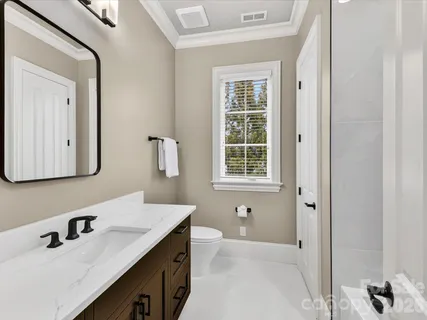 a bathroom with a sink vanity and a mirror