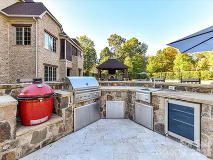 a view of a patio with table and chairs potted plants and a large tree