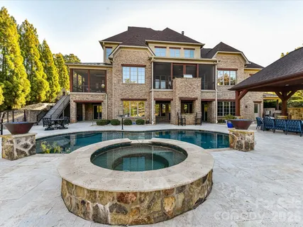 a view of a house with backyard swimming pool
