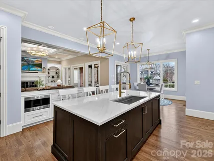 a kitchen with a counter space a sink and cabinets
