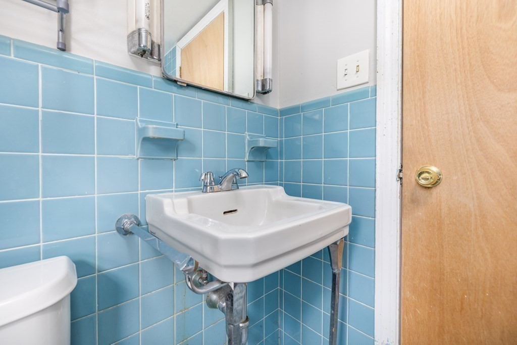 341 Converse Street Longmeadow, MA 01106 - Photo 27 of 34 a bathroom with a sink a toilet and a mirror
