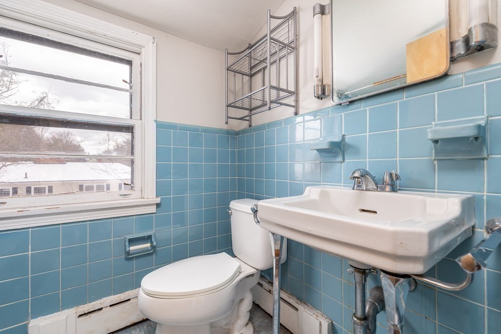 341 Converse Street Longmeadow, MA 01106 - Photo 28 of 34 a bathroom with a sink a toilet and mirror