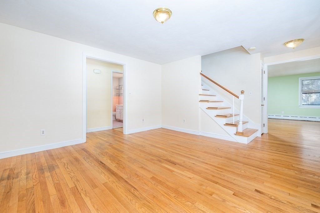 341 Converse Street Longmeadow, MA 01106 - Photo 5 of 34 a view of an empty room with wooden floor and stairs