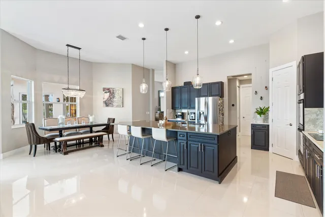 a view of a house with swimming pool and sitting area