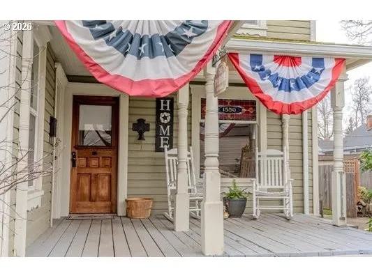a view of a cafe with a small yard and potted plants