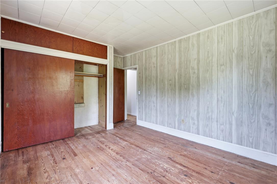 1033 Walt Road Pennsburg, PA 18073 - Photo 25 of 40 Vintage wood paneling and original hardwood flooring define this classic bedroom space.