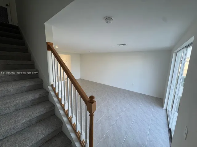 wooden floor in an empty room with stairs