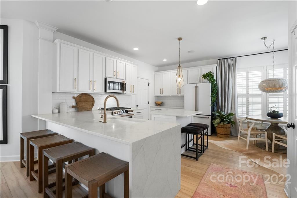 8106 Evanston Falls Road Huntersville, NC 28078 - Photo 11 of 36 a kitchen with refrigerator and chairs