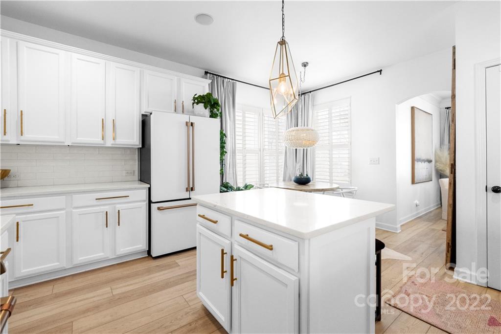 8106 Evanston Falls Road Huntersville, NC 28078 - Photo 14 of 36 a kitchen with white cabinets and white appliances