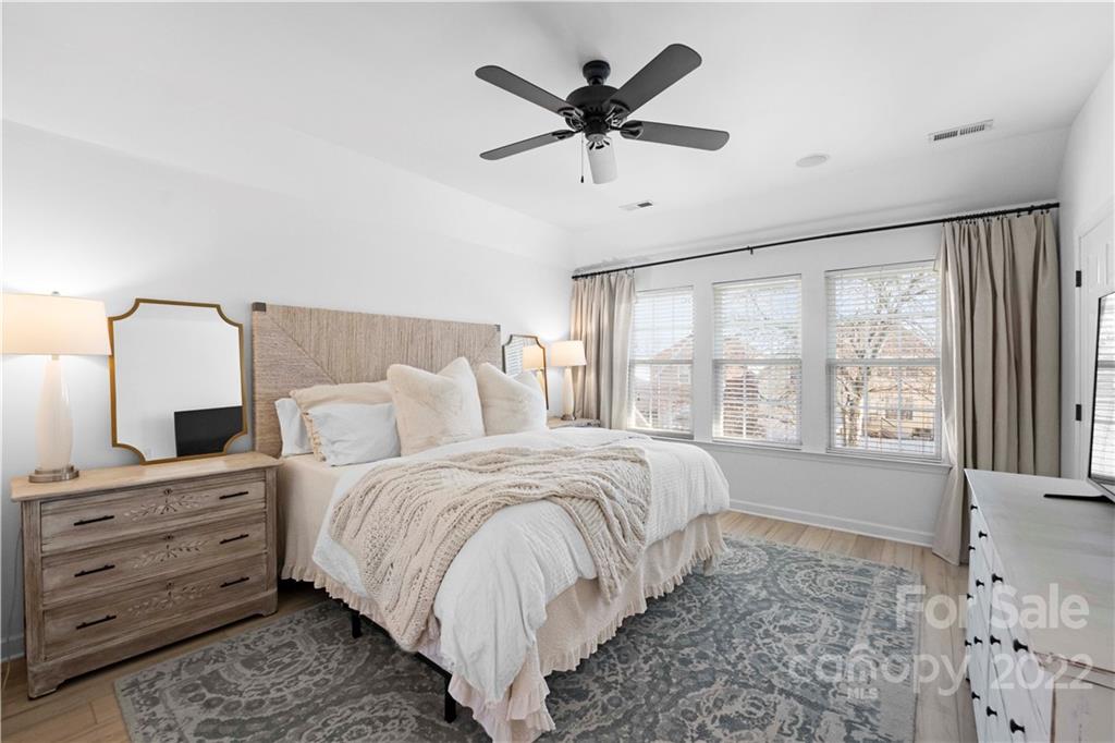8106 Evanston Falls Road Huntersville, NC 28078 - Photo 21 of 36 a spacious bedroom with a bed a dresser and a chandelier