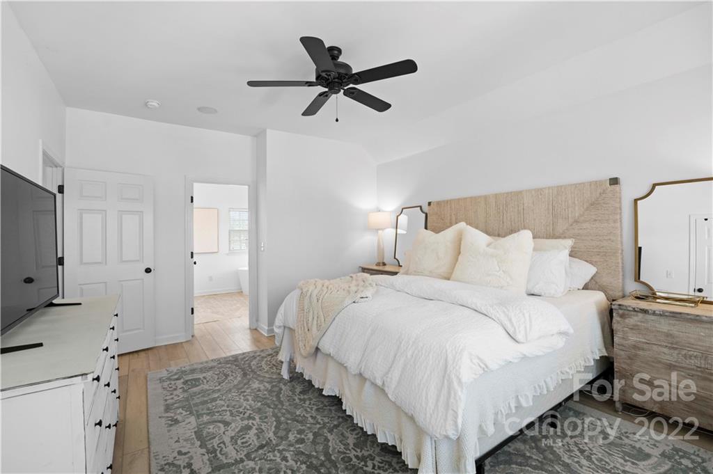 8106 Evanston Falls Road Huntersville, NC 28078 - Photo 23 of 36 a bed room with a bed and a ceiling fan