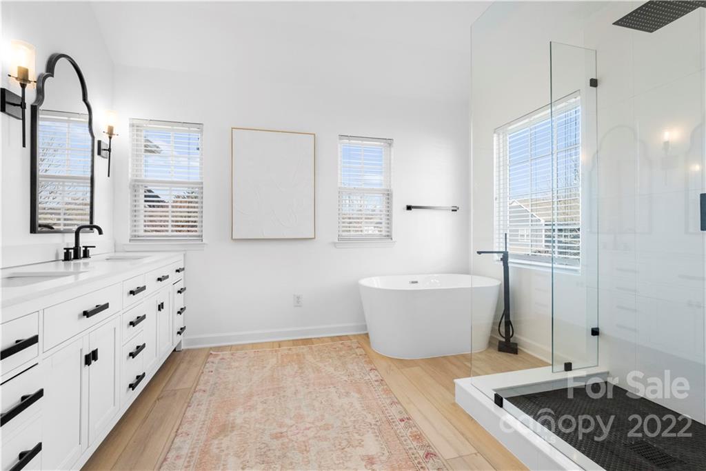 8106 Evanston Falls Road Huntersville, NC 28078 - Photo 24 of 36 a bathroom with a bathtub sink and mirror