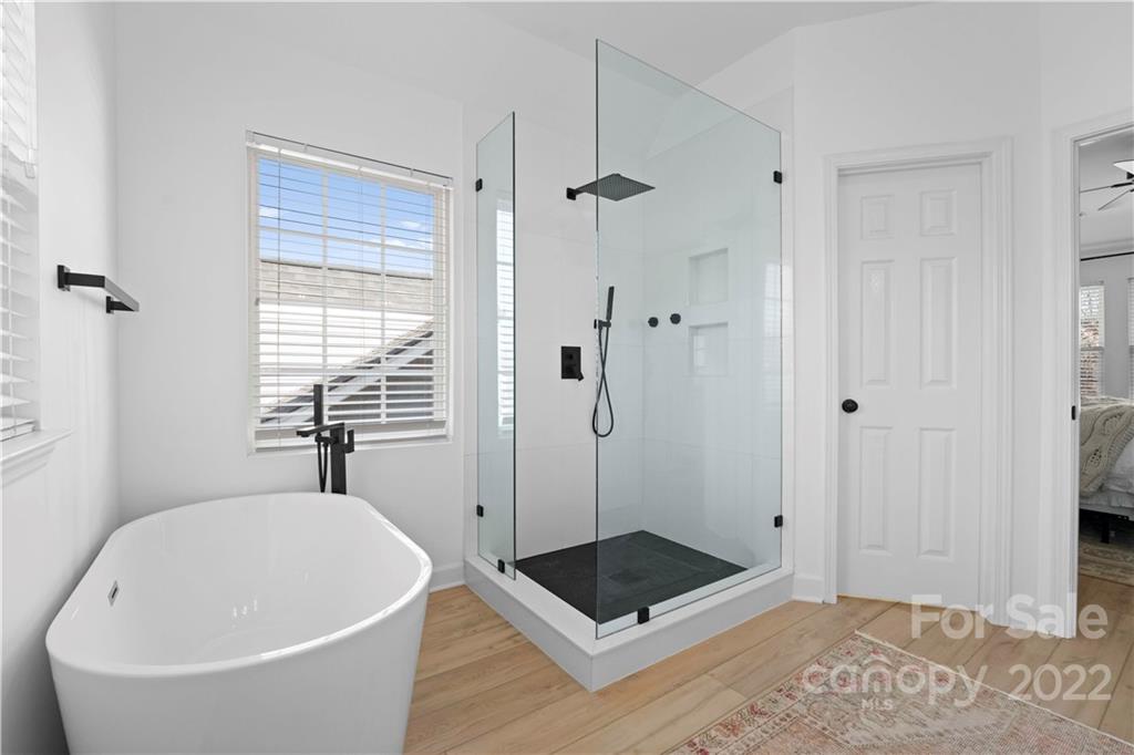 8106 Evanston Falls Road Huntersville, NC 28078 - Photo 25 of 36 a bathroom with a bathtub and shower