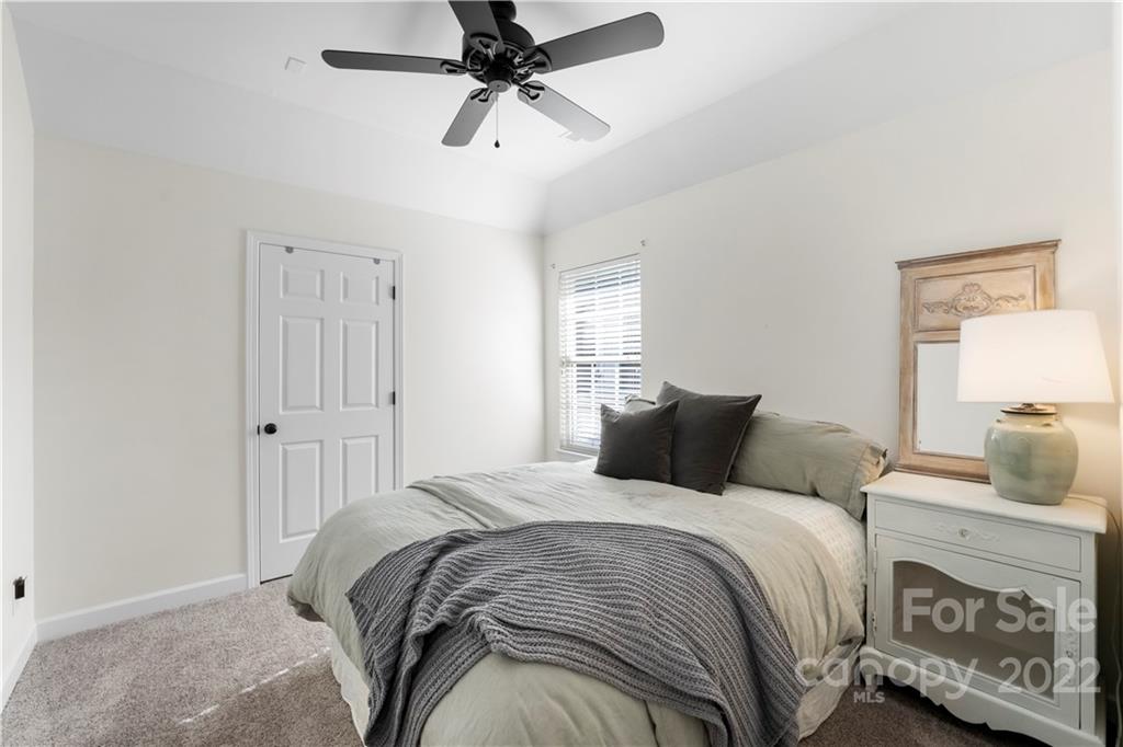 8106 Evanston Falls Road Huntersville, NC 28078 - Photo 27 of 36 a bedroom with a bed and a chandelier