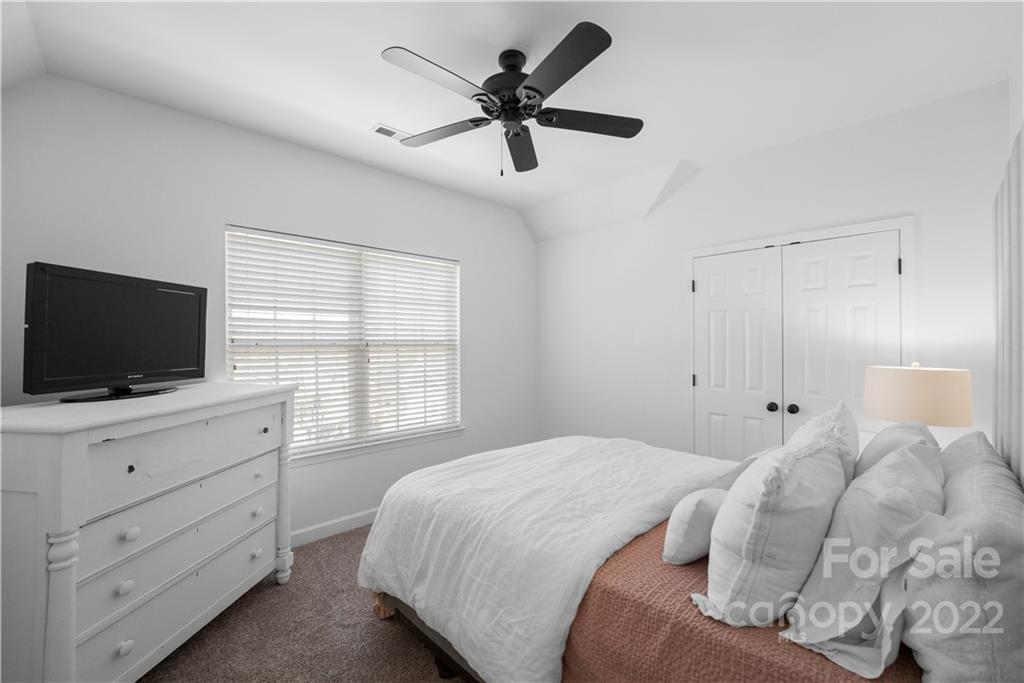 8106 Evanston Falls Road Huntersville, NC 28078 - Photo 28 of 36 a bedroom with a bed and a flat screen tv