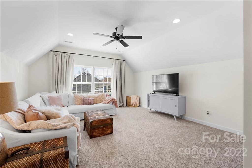 8106 Evanston Falls Road Huntersville, NC 28078 - Photo 29 of 36 a living room with furniture and a flat screen tv