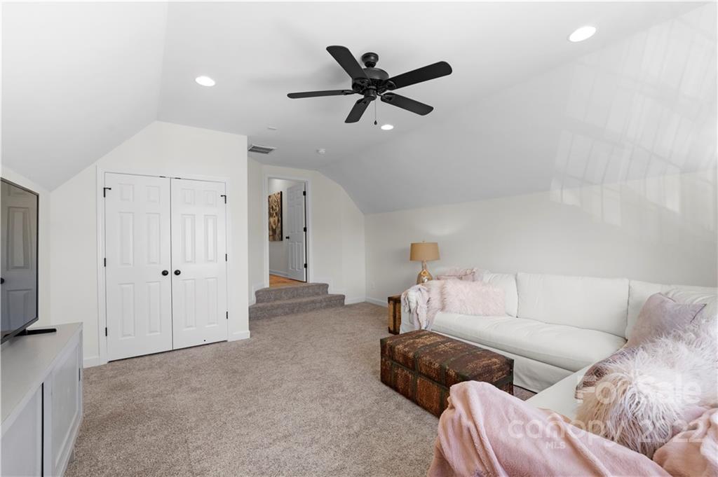8106 Evanston Falls Road Huntersville, NC 28078 - Photo 30 of 36 a living room with furniture and a ceiling fan