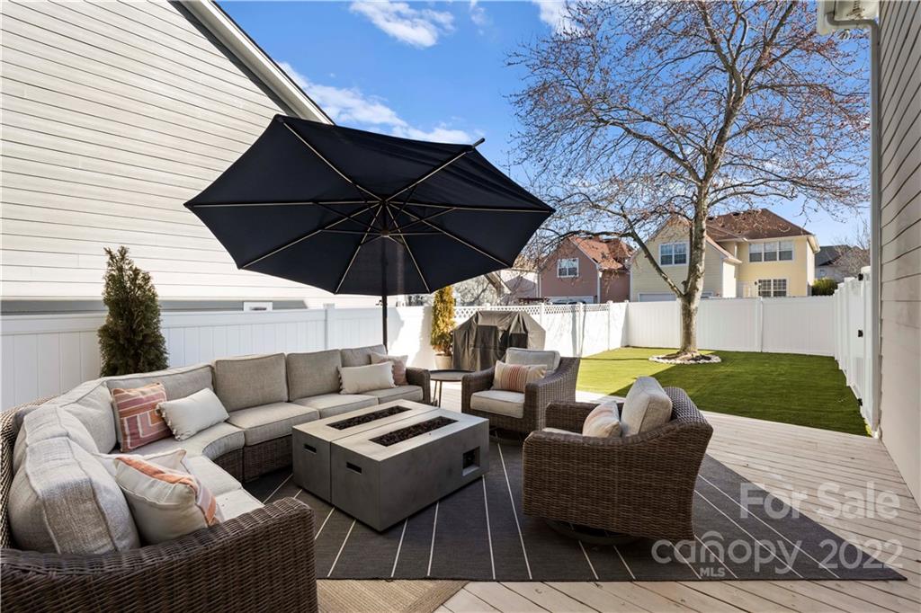 8106 Evanston Falls Road Huntersville, NC 28078 - Photo 4 of 36 a view of an outdoor sitting area with furniture and umbrella