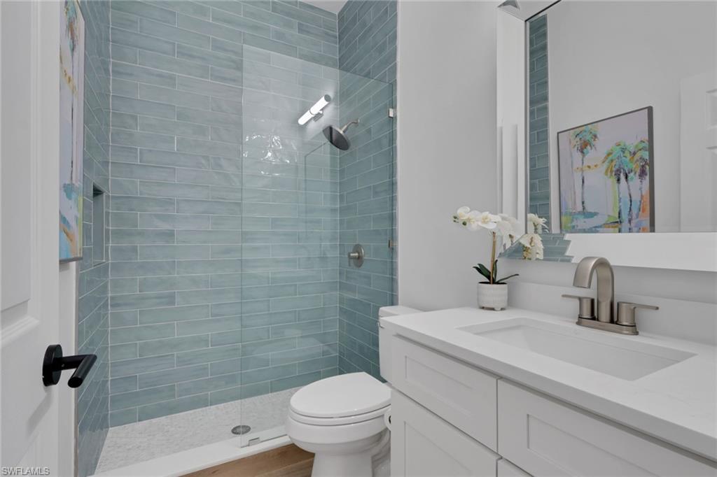136 April Sound Drive Naples, FL 34119 - Photo 14 of 24 a bathroom with a sink a toilet and shower