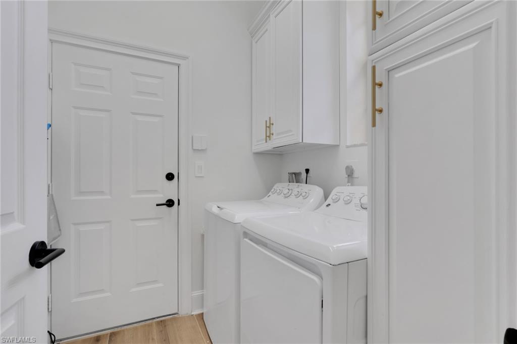 136 April Sound Drive Naples, FL 34119 - Photo 16 of 24 a utility room with dryer and washer
