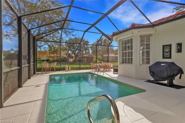 a swimming pool with outdoor seating and yard