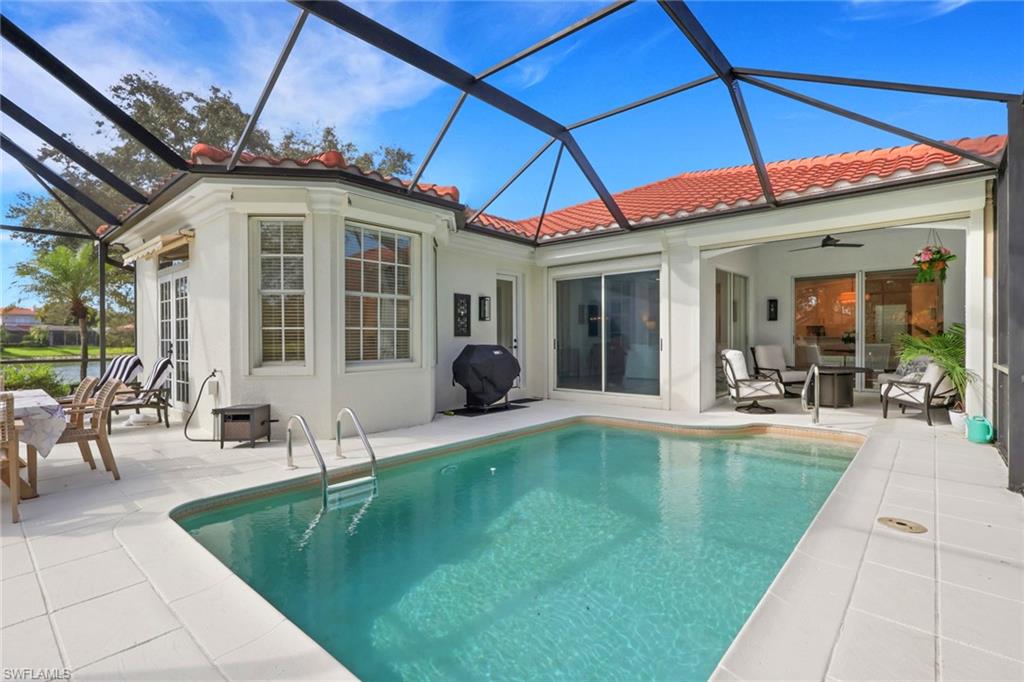 136 April Sound Drive Naples, FL 34119 - Photo 19 of 24 a swimming pool with outdoor seating and yard