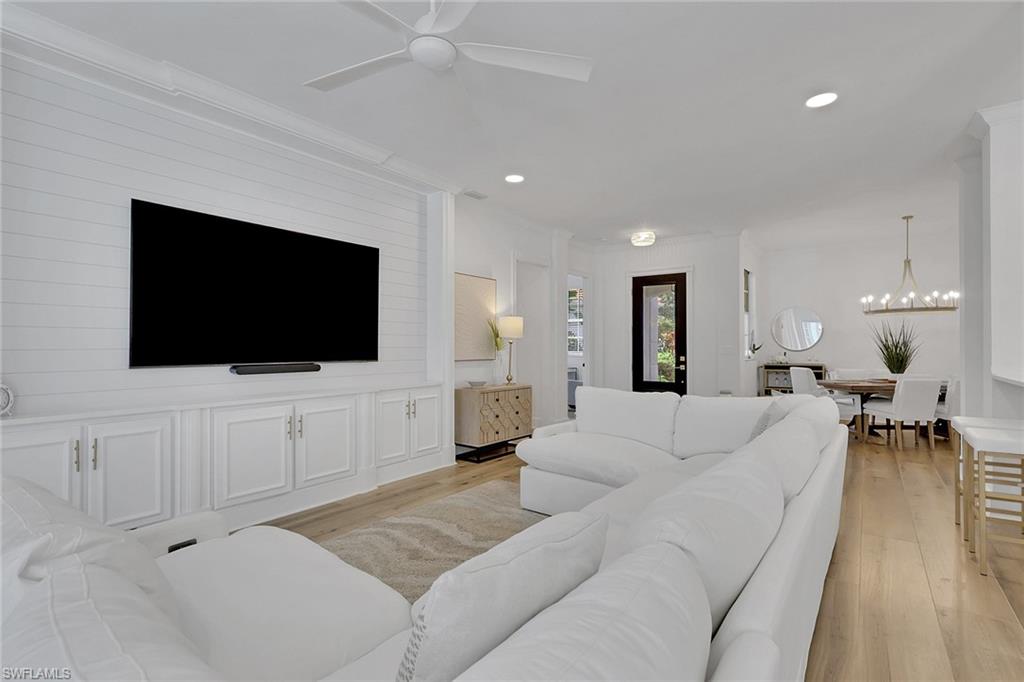 136 April Sound Drive Naples, FL 34119 - Photo 2 of 24 a living room with furniture and a flat screen tv