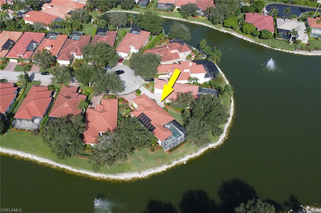 136 April Sound Drive Naples, FL 34119 - Photo 21 of 24 an aerial view of a house with outdoor space and a lake view