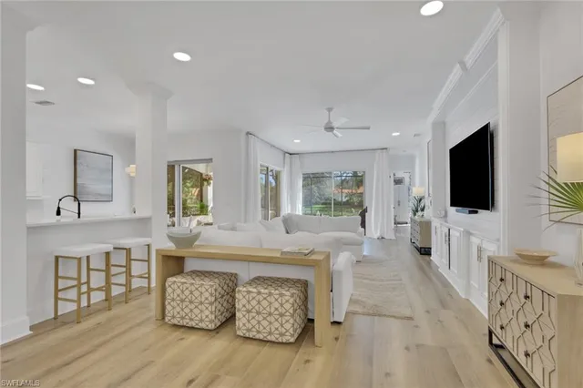 a view of a dining room with furniture a chandelier window and wooden floor