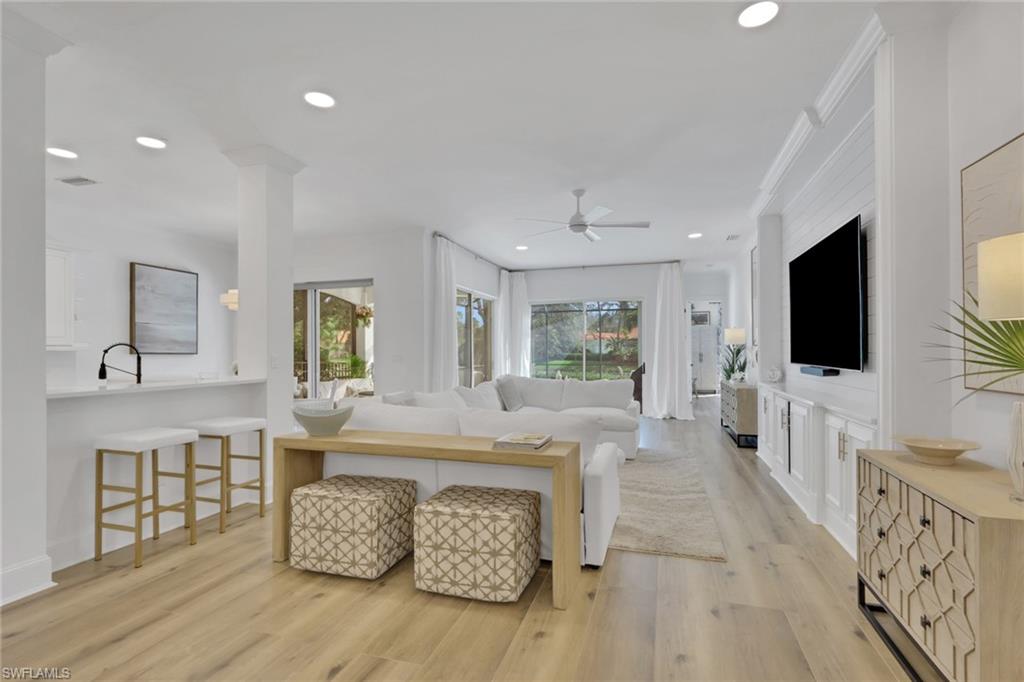 136 April Sound Drive Naples, FL 34119 - Photo 4 of 24 a view of living room filled with furniture and flat screen tv