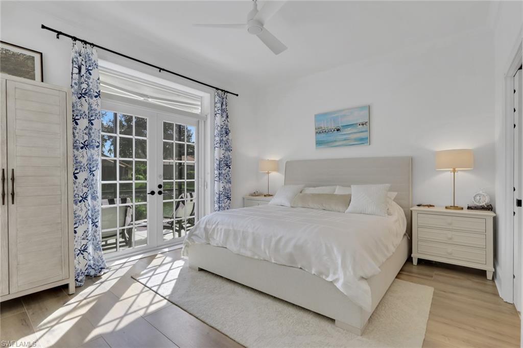 136 April Sound Drive Naples, FL 34119 - Photo 9 of 24 a bedroom with a bed and a large window