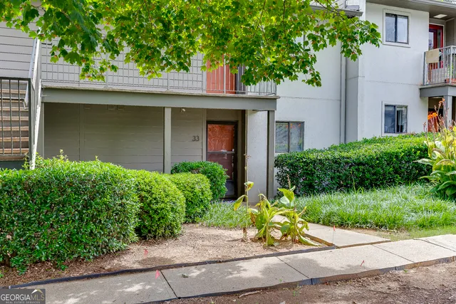 a front view of a house with a yard and a bench